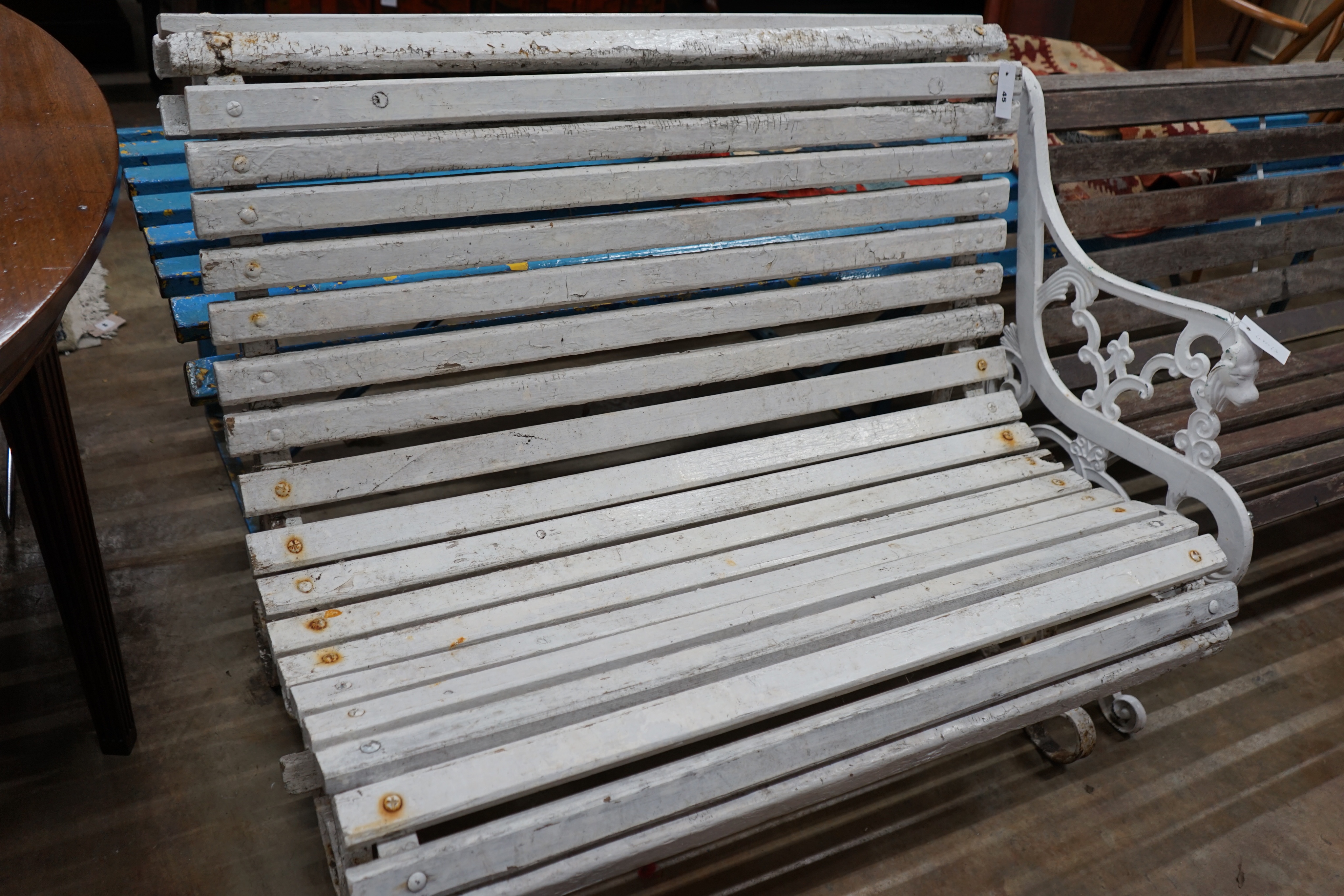 A painted slatted wood and wrought iron garden bench, length 106cm depth 74cm height 84cm